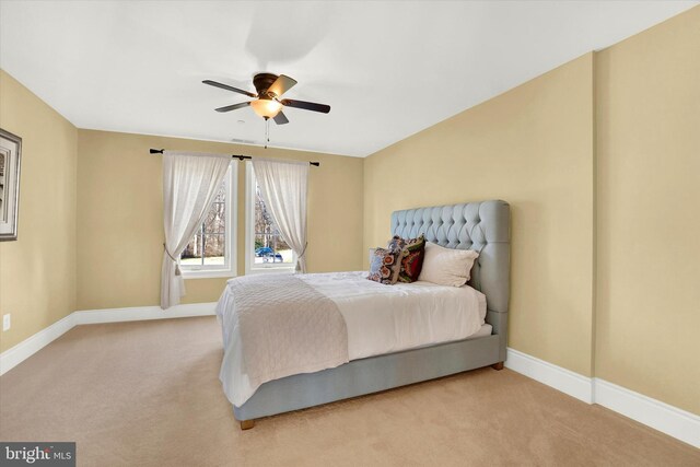 bedroom with ceiling fan and light carpet