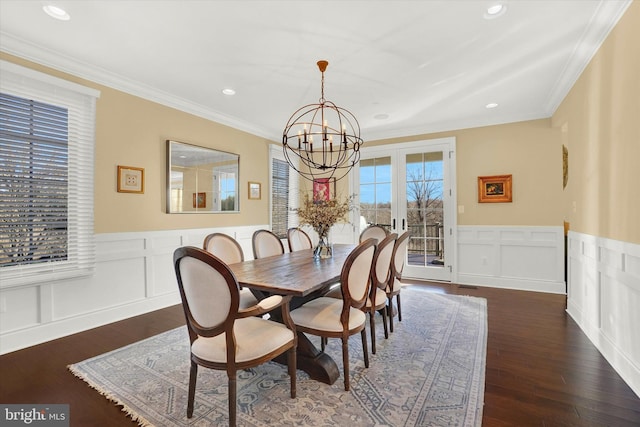 dining room featuring french doors, dark wood-type flooring, an inviting chandelier, and crown molding