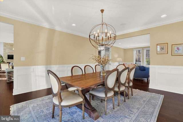 dining room with dark hardwood / wood-style flooring, crown molding, and a notable chandelier