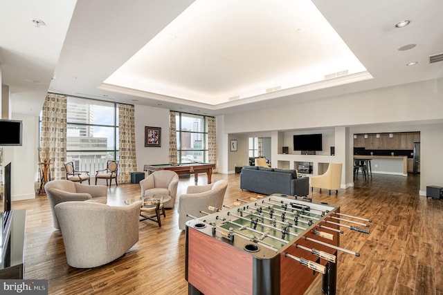 rec room featuring a tray ceiling, dark hardwood / wood-style flooring, and pool table