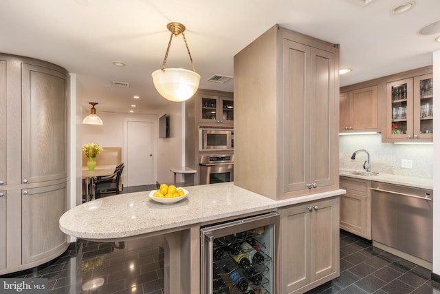 kitchen with wine cooler, appliances with stainless steel finishes, dark tile flooring, hanging light fixtures, and sink