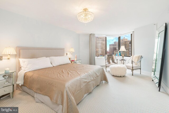 carpeted bedroom featuring a notable chandelier