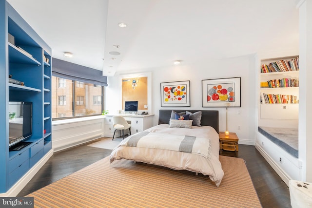 bedroom with dark hardwood / wood-style flooring