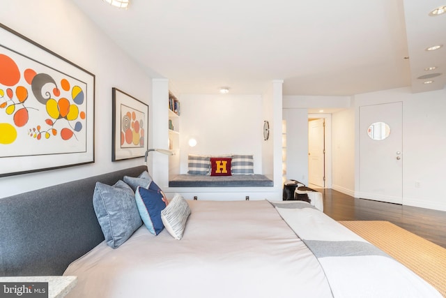 bedroom with dark hardwood / wood-style floors