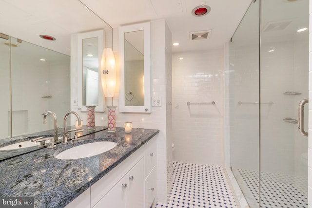 bathroom with large vanity and an enclosed shower