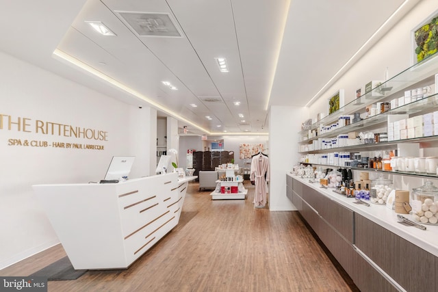 interior space with white cabinets and light wood-type flooring