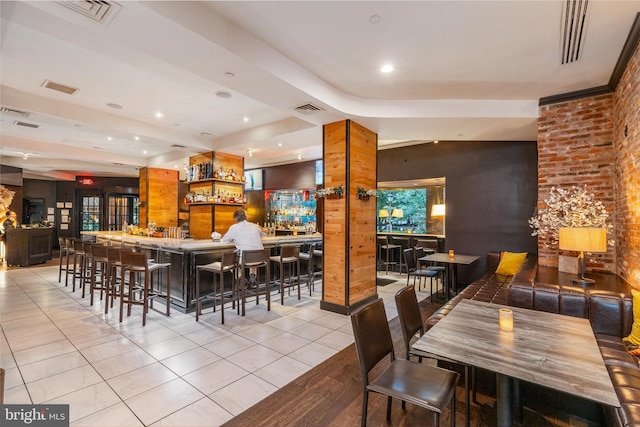 tiled dining room featuring indoor bar