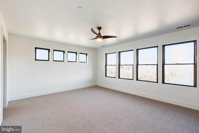 unfurnished room with carpet and ceiling fan