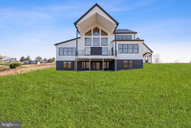 back of house featuring a wooden deck and a yard