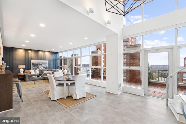 dining room with a towering ceiling