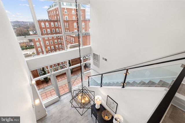 stairway featuring a healthy amount of sunlight and a high ceiling