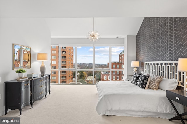 bedroom featuring light carpet and an inviting chandelier