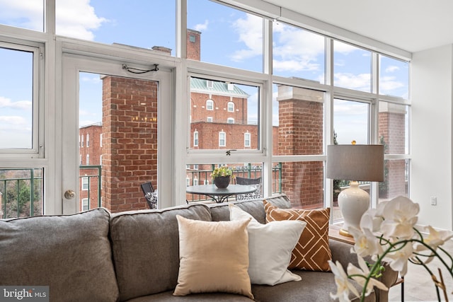 living room featuring a wealth of natural light and a wall of windows