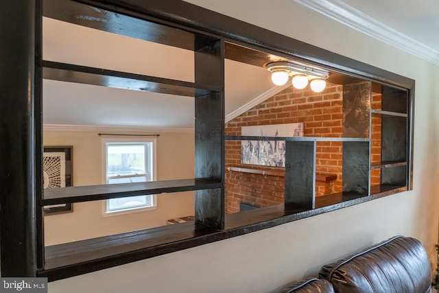 corridor featuring ornamental molding and brick wall