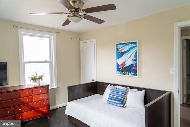 bedroom with ceiling fan and dark hardwood / wood-style flooring