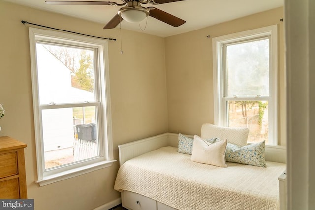 bedroom featuring multiple windows and ceiling fan