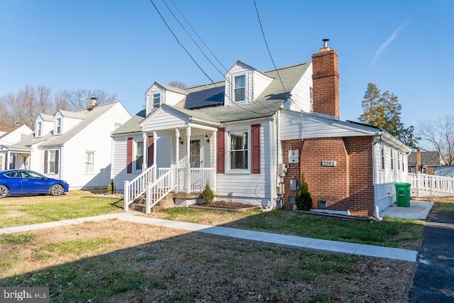 cape cod home with a front lawn