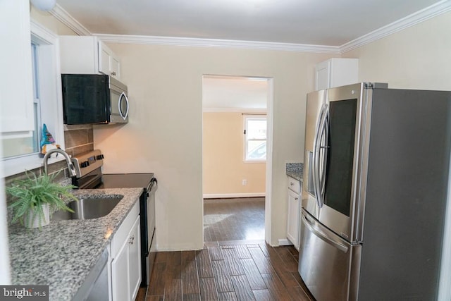 kitchen featuring dark hardwood / wood-style floors, light stone countertops, white cabinetry, and stainless steel appliances