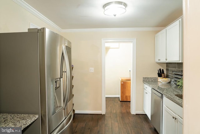 kitchen with white cabinets, dark hardwood / wood-style flooring, light stone counters, and stainless steel appliances