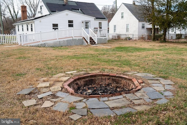 view of yard featuring a fire pit and a wooden deck