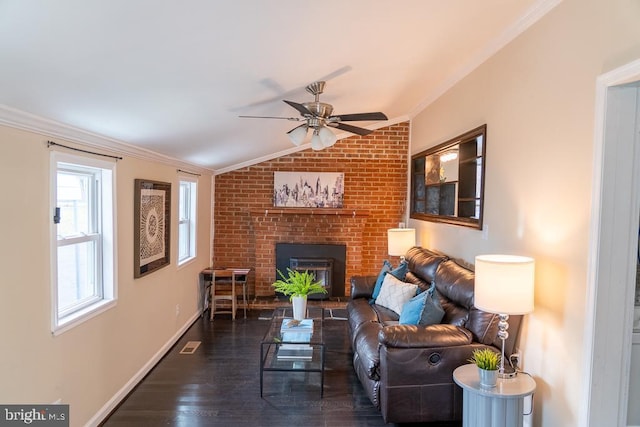 living room with a fireplace, ceiling fan, crown molding, and vaulted ceiling