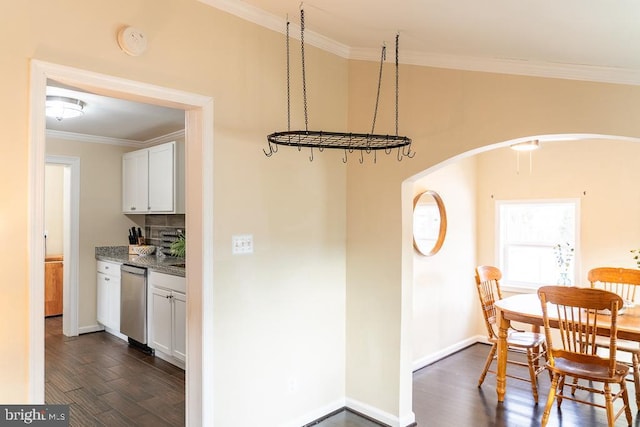 dining area with dark hardwood / wood-style flooring and ornamental molding