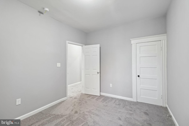 unfurnished bedroom with light colored carpet