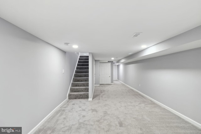 basement featuring light carpet