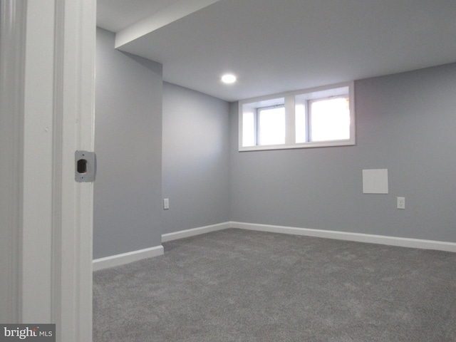 basement with dark colored carpet