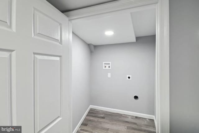 clothes washing area featuring washer hookup, hardwood / wood-style flooring, and electric dryer hookup