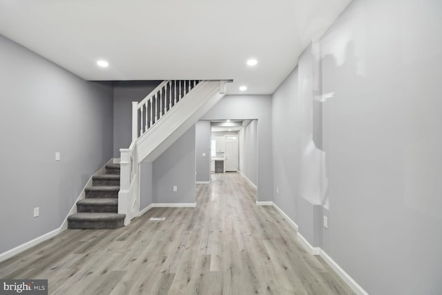 corridor with light hardwood / wood-style floors