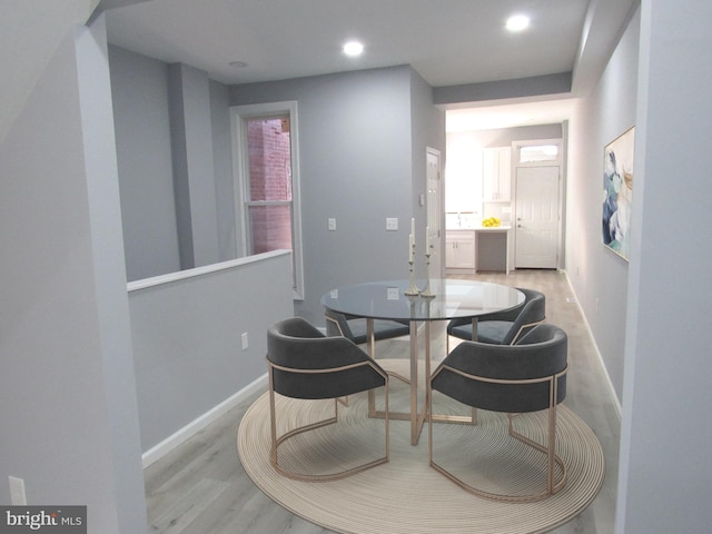 dining space with plenty of natural light and light hardwood / wood-style flooring