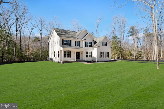 view of front of home featuring central air condition unit and a front lawn