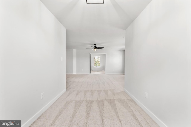 unfurnished room featuring light carpet and ceiling fan