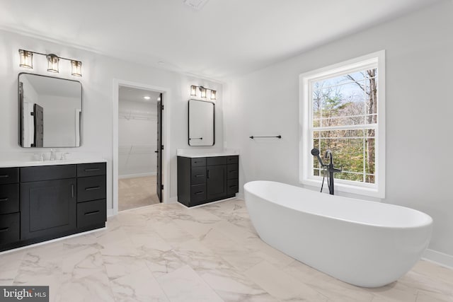 bathroom featuring oversized vanity, a washtub, and tile flooring