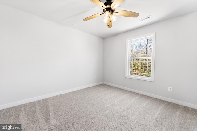 empty room featuring ceiling fan and light colored carpet