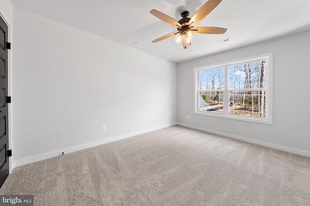 empty room featuring light colored carpet and ceiling fan