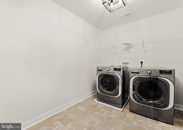 washroom featuring washer and clothes dryer, washer hookup, and light tile floors