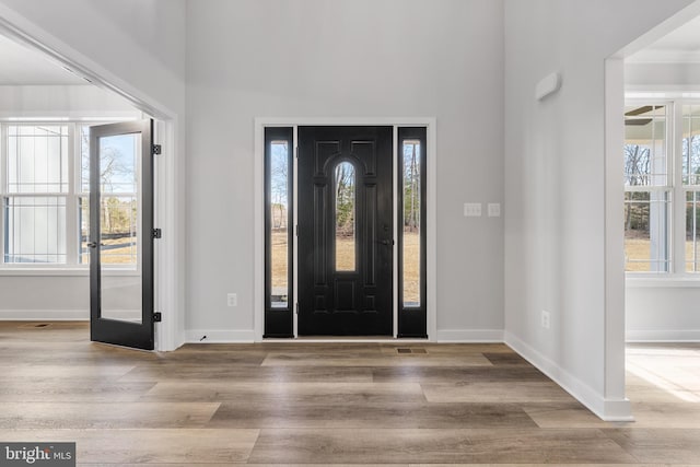 entrance foyer with french doors and light hardwood / wood-style flooring