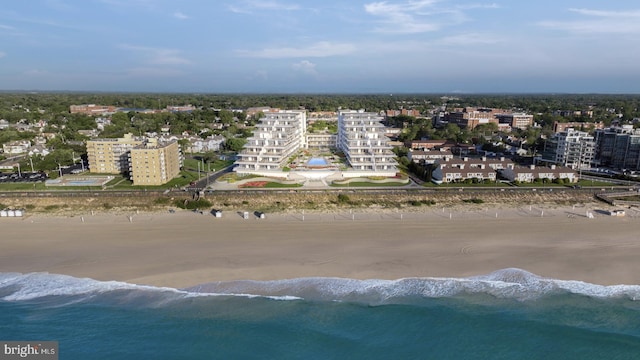 drone / aerial view featuring a water view and a beach view