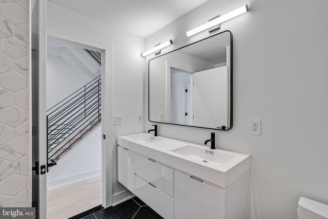 bathroom featuring vanity, wood-type flooring, and toilet