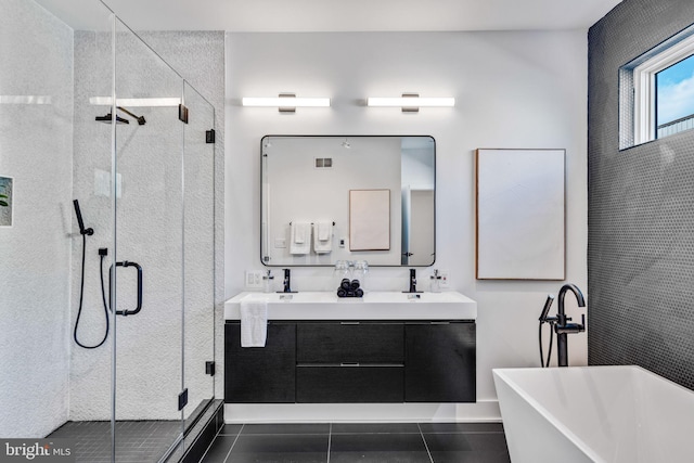 bathroom with tile patterned flooring, vanity, and separate shower and tub