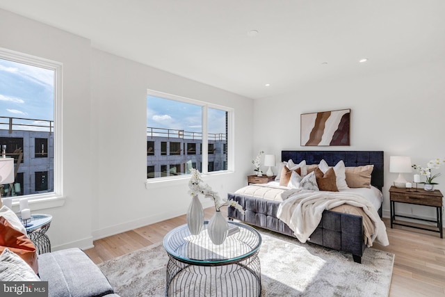 bedroom featuring multiple windows and light hardwood / wood-style floors