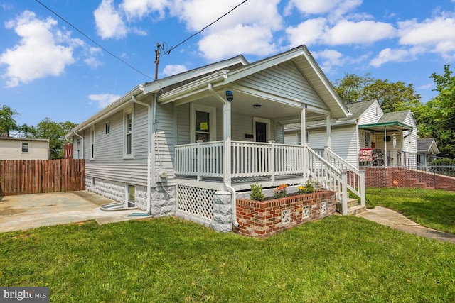 bungalow-style house with covered porch and a front yard