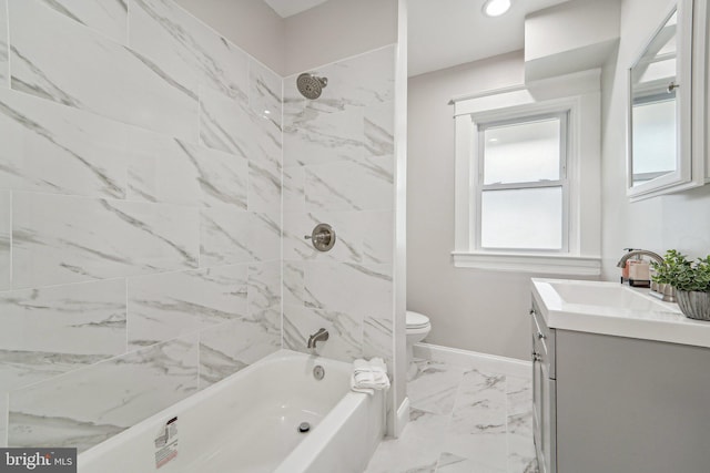 full bathroom with tiled shower / bath combo, vanity, and toilet