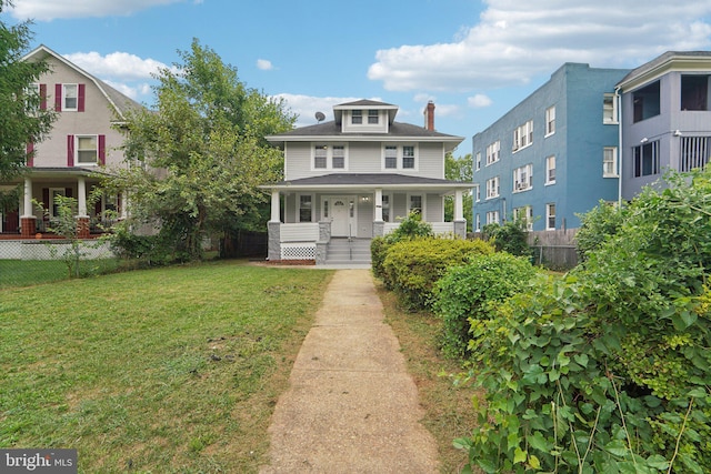 view of front of home with covered porch and a front lawn