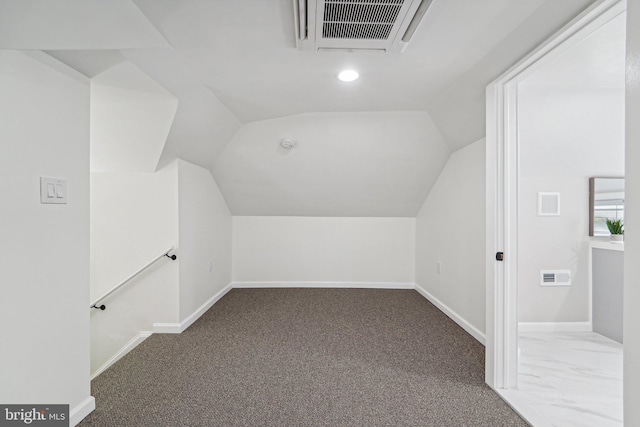 additional living space featuring carpet flooring and vaulted ceiling