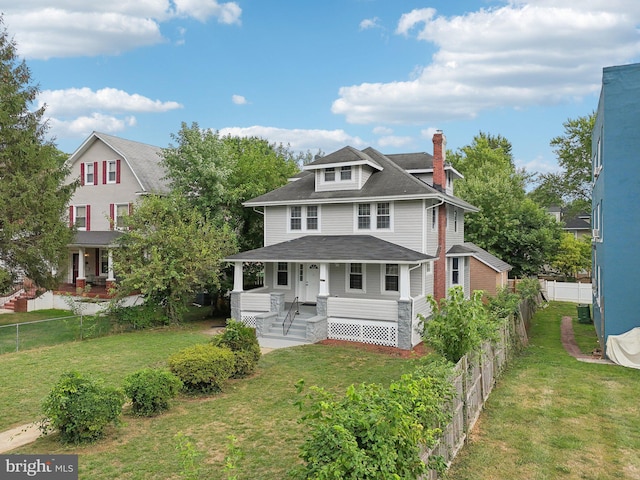 view of front facade with central AC, covered porch, and a front lawn