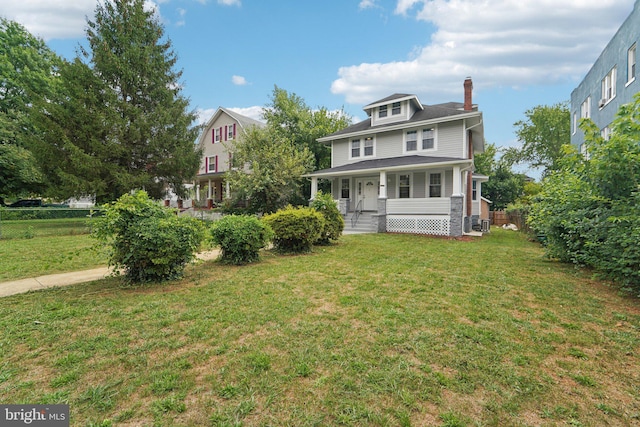 view of front of house with covered porch and a front yard