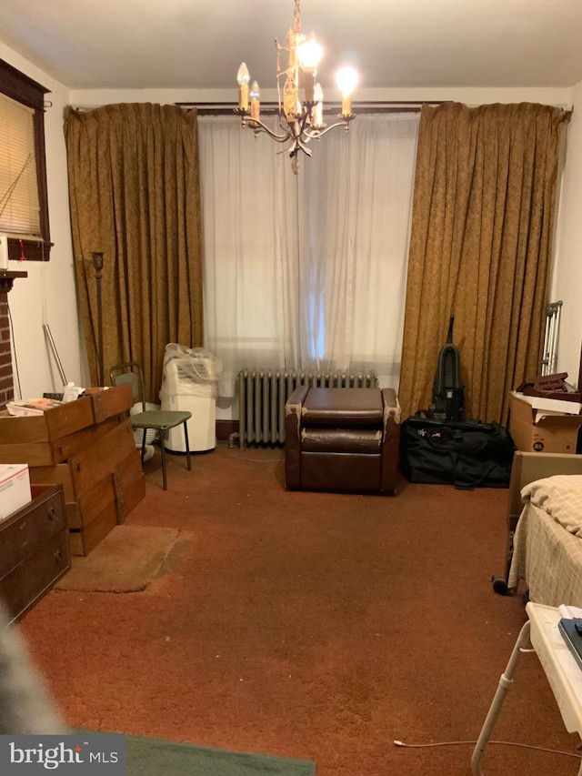 living area featuring carpet floors, radiator heating unit, and a chandelier